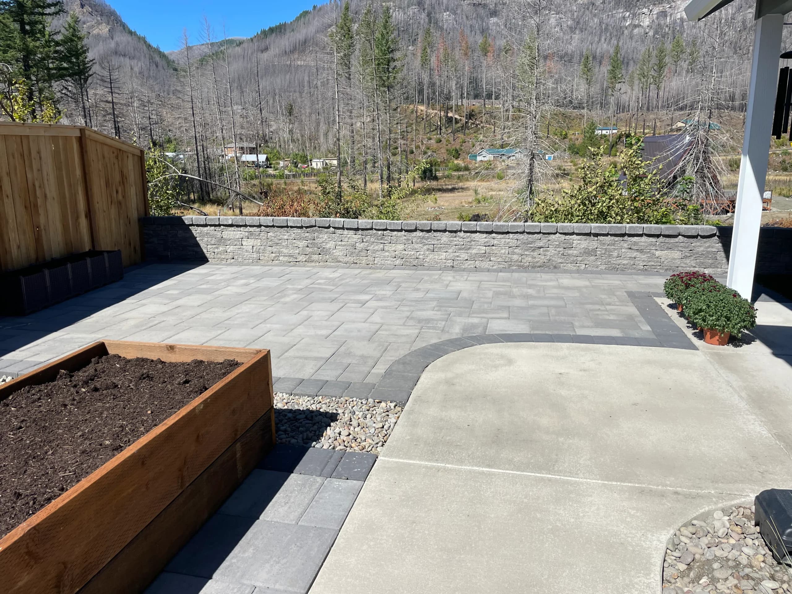 Cinematic paver patio with mountain backdrop by GI Landscape