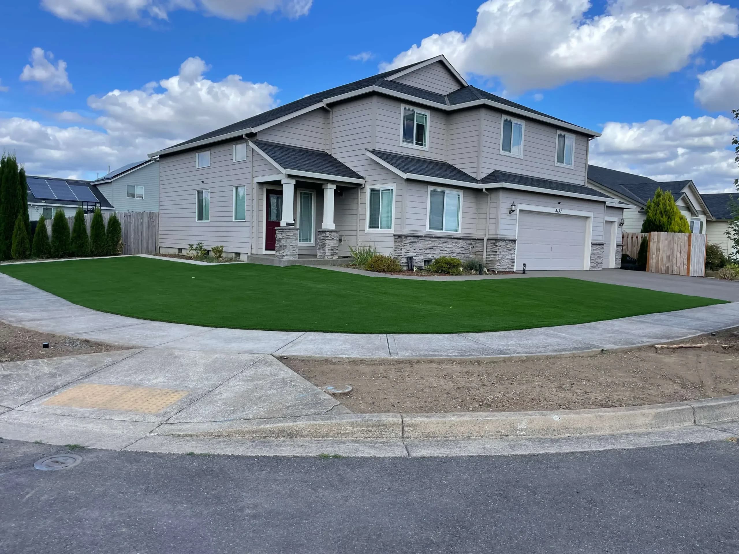 High-end paver and artificial turf combination by GI Landscape
